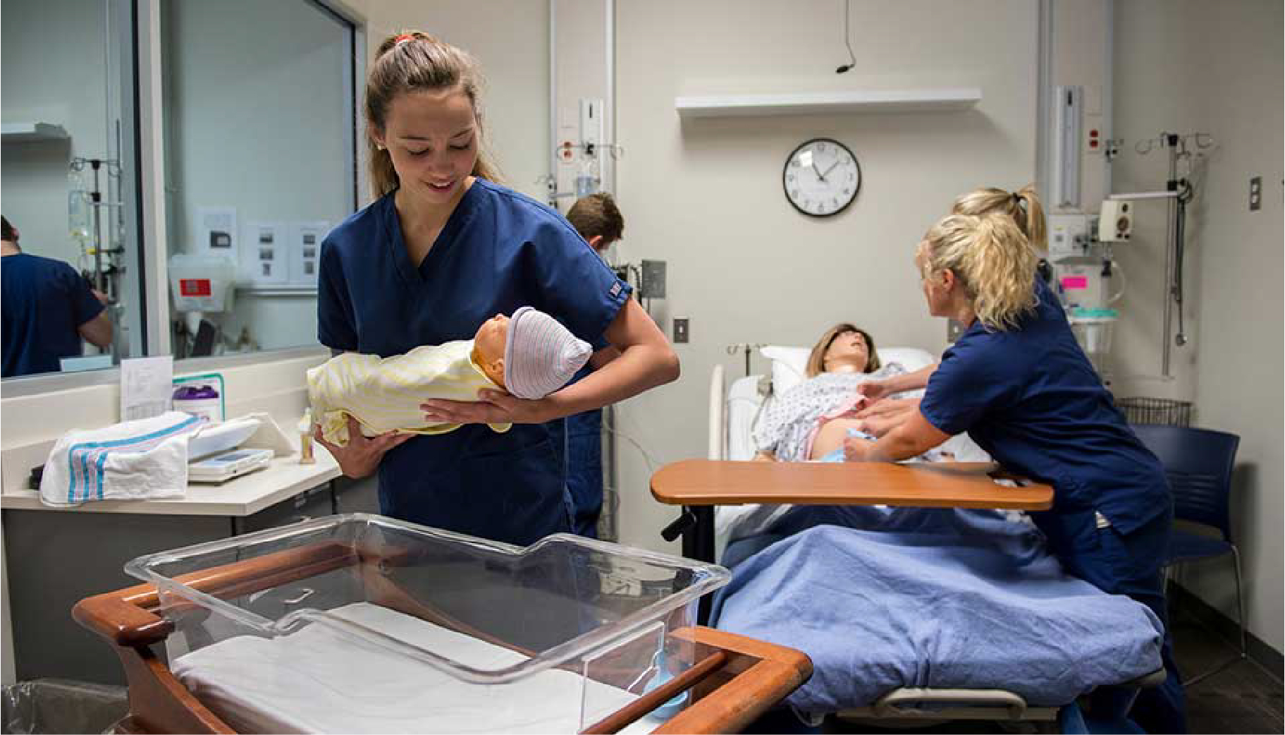 Nursing students holding a baby