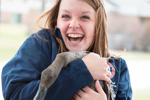 student with duck at animal fair in front of UVs