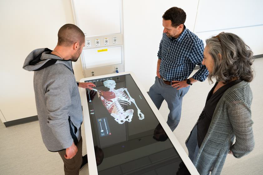 Anatomage table used by three people