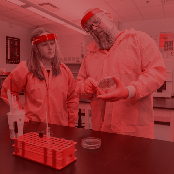 student working with instructor in a lab
