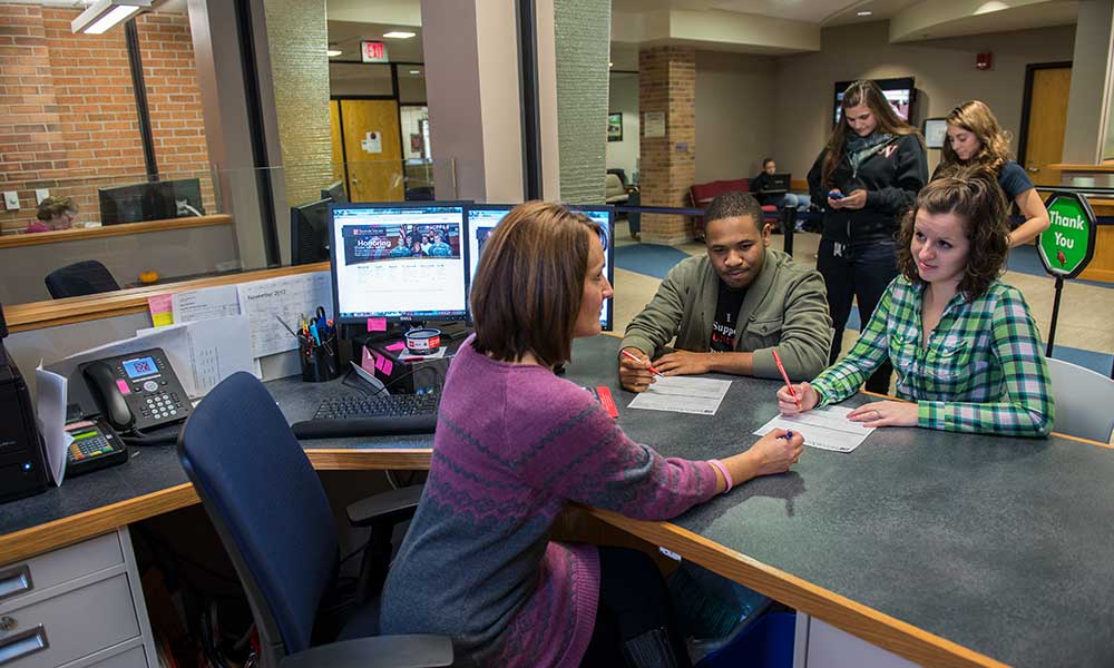 students getting assistance at registrar and financial aid office