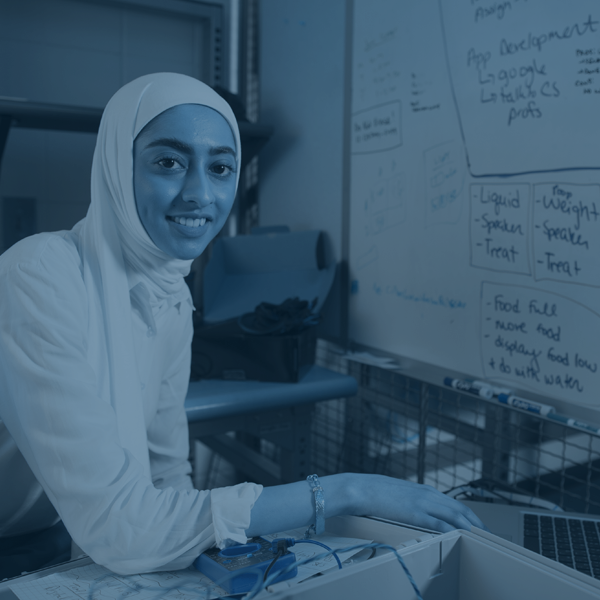 female electrical engineering student working in front of whiteboard