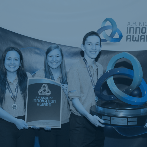 Students holding math innovation trophies from a competition