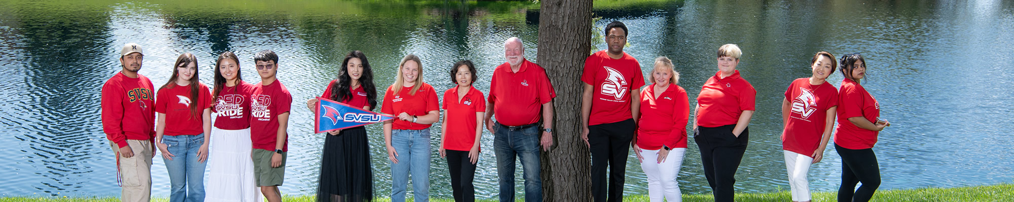 Office of International Programs staff next to pond